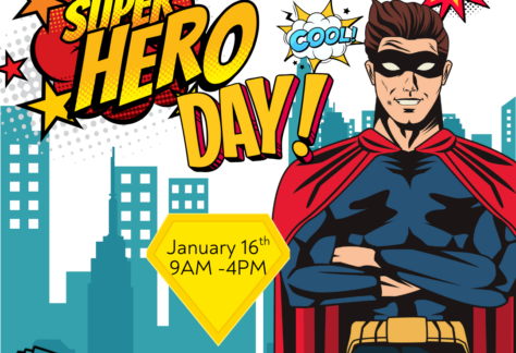 Blue cityscape background with large image of superhero on right side. Text says "Super Hero Day."